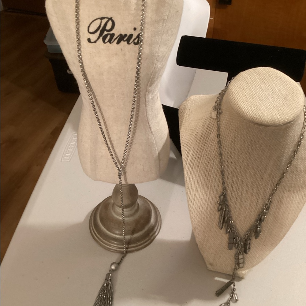 Two silver tassel necklaces, one with glass accents